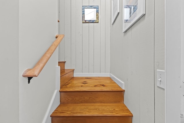 staircase with wood walls