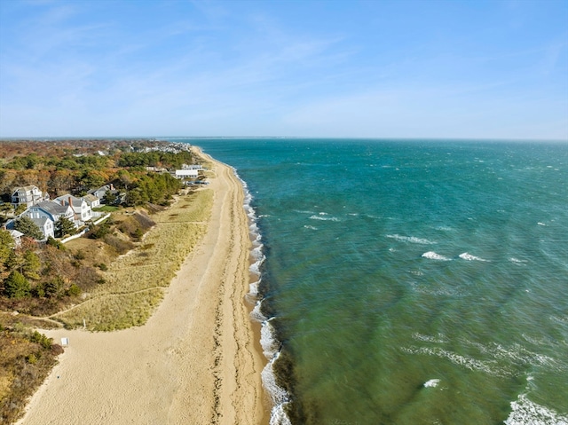 drone / aerial view featuring a beach view and a water view