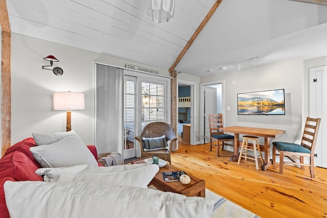 living room with hardwood / wood-style flooring and vaulted ceiling