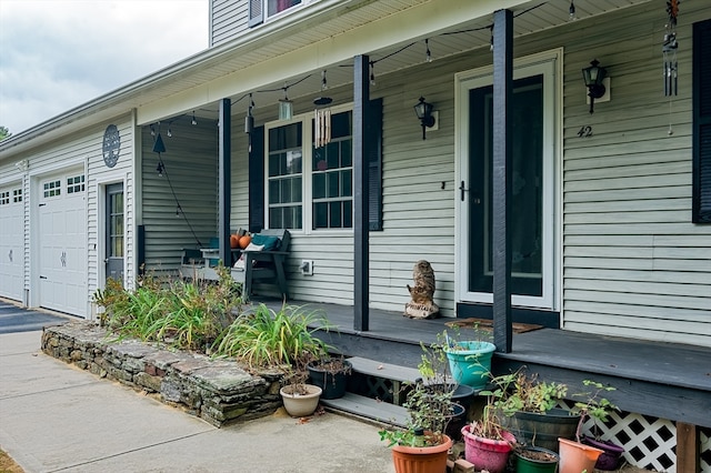 entrance to property featuring a porch and a garage