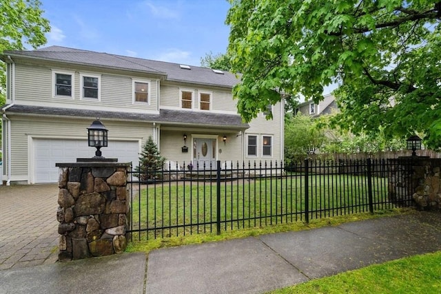 view of front facade with a front lawn, decorative driveway, an attached garage, and a fenced front yard