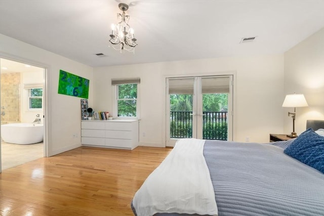 bedroom with visible vents, connected bathroom, wood finished floors, access to exterior, and a notable chandelier