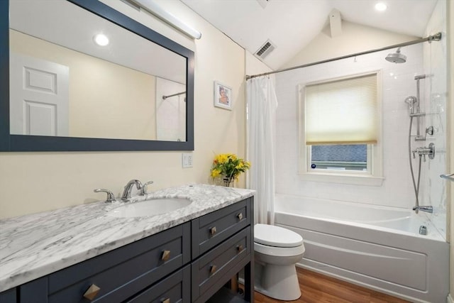 bathroom with visible vents, toilet, shower / bath combo, vanity, and wood finished floors