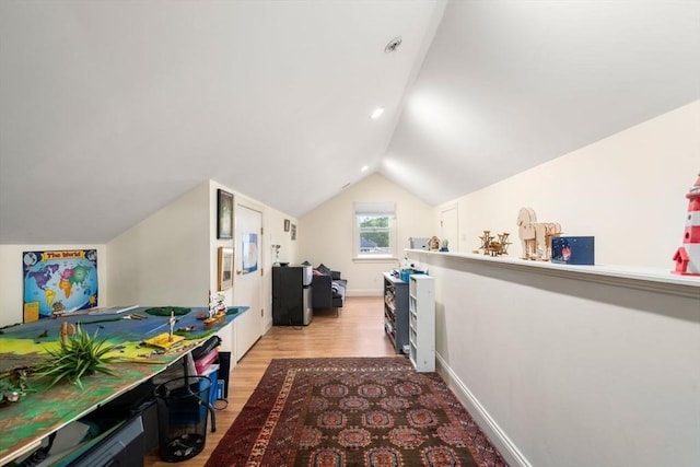 interior space with lofted ceiling, light wood finished floors, and baseboards