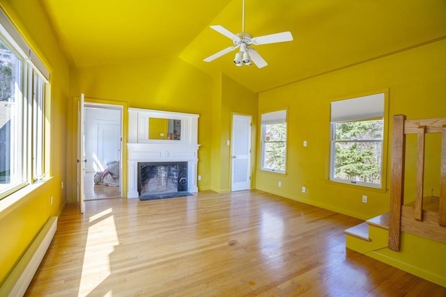 15 Estes, Amesbury, MA 01913 - unfurnished living room featuring a baseboard heating unit, light wood-type flooring, a fireplace, lofted ceiling, and ceiling fan