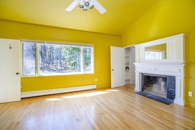 15 Estes, Amesbury, MA 01913 - unfurnished living room with baseboards, a fireplace, a ceiling fan, a baseboard radiator, and wood finished floors