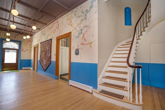 15 Estes, Amesbury, MA 01913 - staircase featuring wood-type flooring, a wainscoted wall, baseboard heating, and wallpapered walls