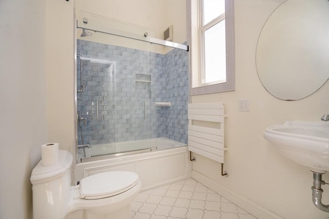 15 Estes, Amesbury, MA 01913 - bathroom with baseboards, toilet, radiator heating unit, shower / bath combination with glass door, and tile patterned floors