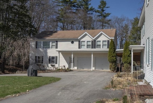 15 Estes, Amesbury, MA 01913 - view of front of home with an attached garage, a front lawn, and aphalt driveway