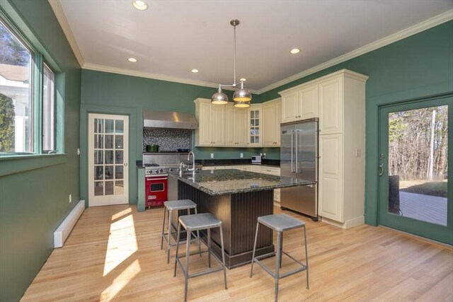 15 Estes, Amesbury, MA 01913 - kitchen with light wood-style flooring, crown molding, high quality appliances, and wall chimney range hood