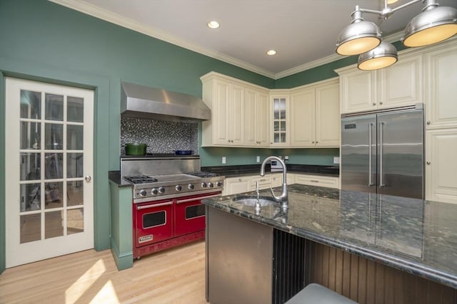 15 Estes, Amesbury, MA 01913 - kitchen with light wood-type flooring, stainless steel built in refrigerator, wall chimney range hood, double oven range, and a sink