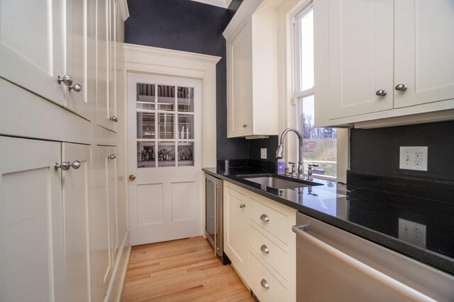 15 Estes, Amesbury, MA 01913 - kitchen with white cabinets, a sink, light wood-type flooring, dark stone counters, and stainless steel dishwasher