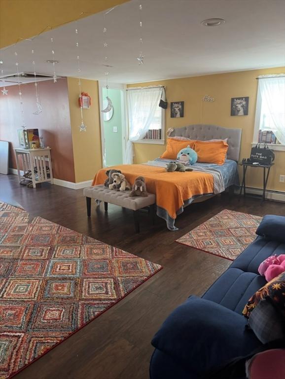 13 Coombs St, Southbridge, MA 01550 - bedroom featuring baseboard heating, wood finished floors, and baseboards
