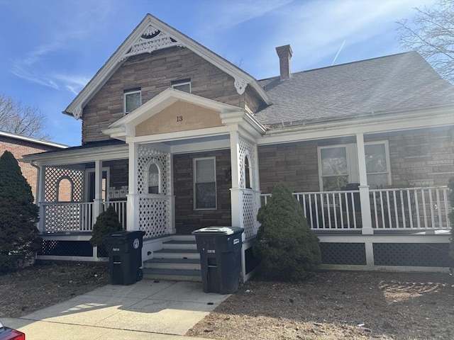 13 Coombs St, Southbridge, MA 01550 - view of front facade with roof with shingles, a porch, and stone siding