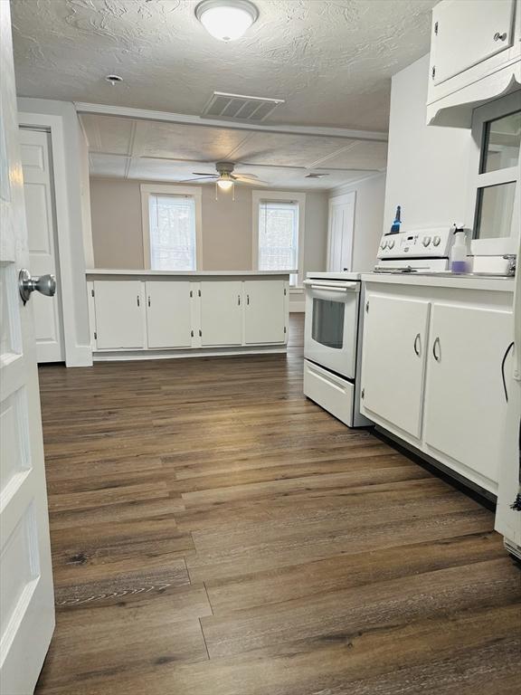 13 Coombs St, Southbridge, MA 01550 - kitchen with visible vents, white cabinets, and white range with electric stovetop