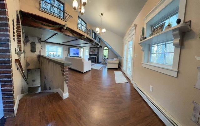 13 Coombs St, Southbridge, MA 01550 - unfurnished living room with a baseboard heating unit, baseboards, an inviting chandelier, a fireplace, and wood finished floors