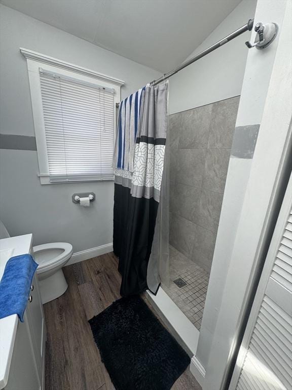 13 Coombs St, Southbridge, MA 01550 - bathroom featuring wood finished floors, a tile shower, toilet, and vanity