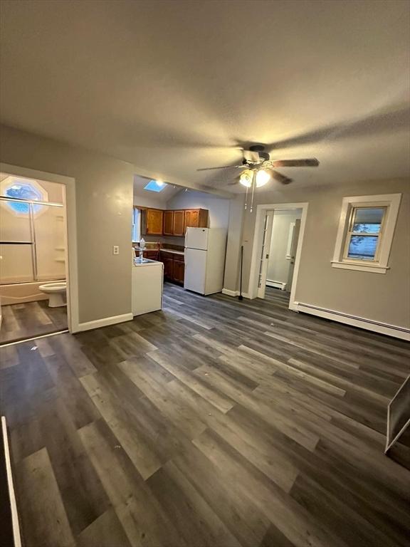 13 Coombs St, Southbridge, MA 01550 - unfurnished living room with dark wood finished floors, a baseboard radiator, a baseboard heating unit, ceiling fan, and baseboards