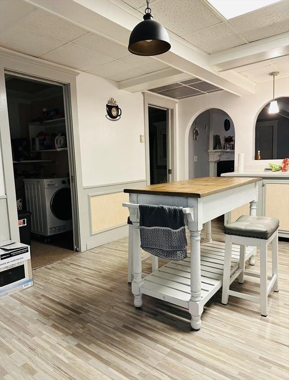 13 Coombs St, Southbridge, MA 01550 - interior space with arched walkways, light wood-style floors, washer / dryer, beam ceiling, and pendant lighting