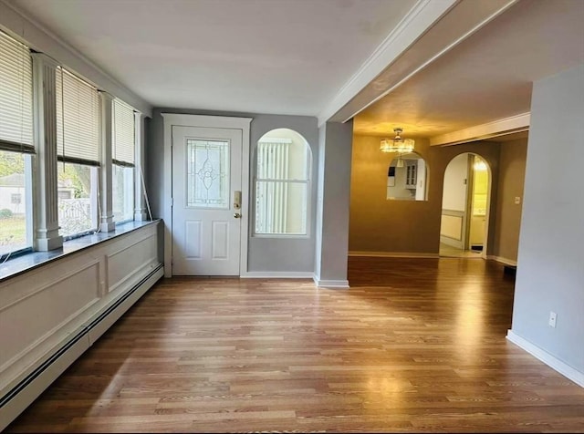 13 Coombs St, Southbridge, MA 01550 - entryway with a chandelier, light wood-style flooring, baseboards, arched walkways, and baseboard heating