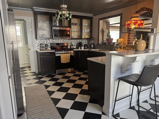 13 Coombs St, Southbridge, MA 01550 - kitchen with a sink, stainless steel appliances, a peninsula, dark cabinets, and light floors