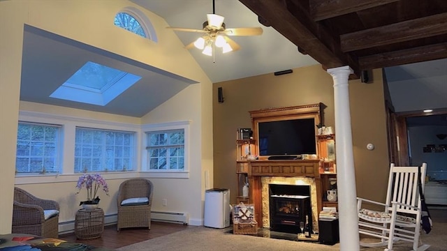 13 Coombs St, Southbridge, MA 01550 - living area featuring a baseboard heating unit, ceiling fan, vaulted ceiling with skylight, and ornate columns