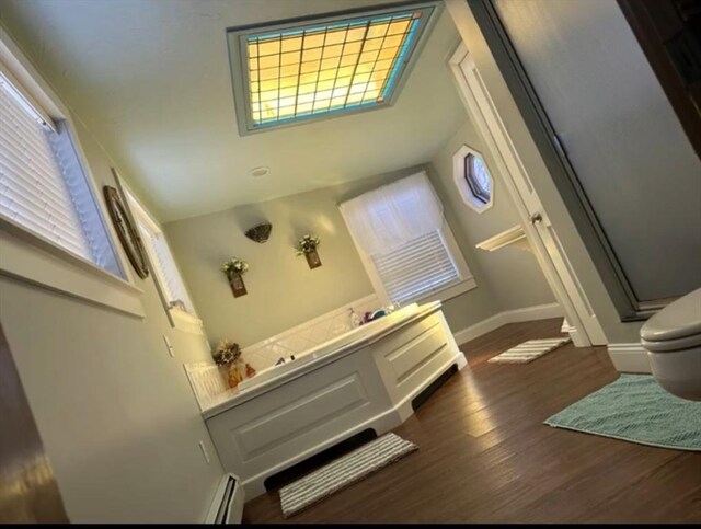 13 Coombs St, Southbridge, MA 01550 - full bathroom featuring a shower stall, a baseboard radiator, baseboards, toilet, and wood finished floors