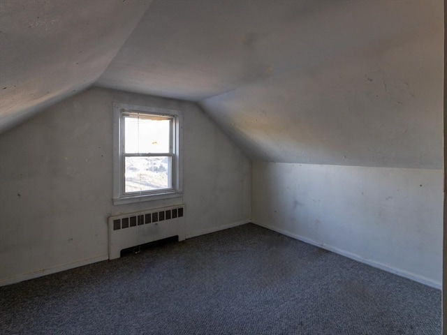 bonus room with carpet flooring, radiator, and lofted ceiling