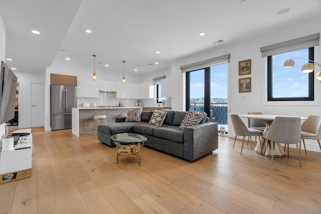 living room with light hardwood / wood-style flooring