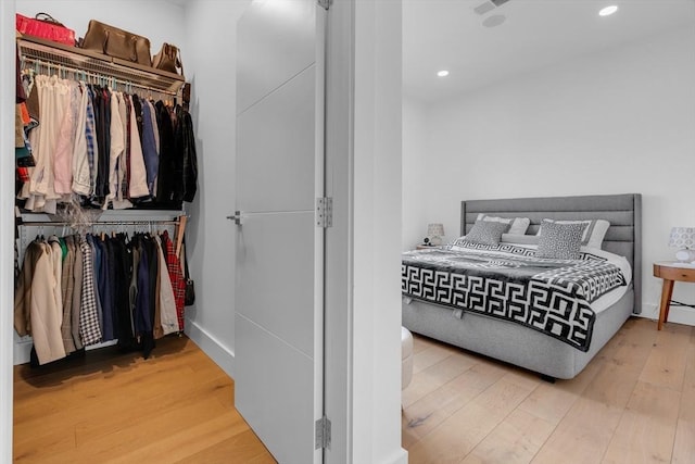 bedroom featuring wood-type flooring and a closet