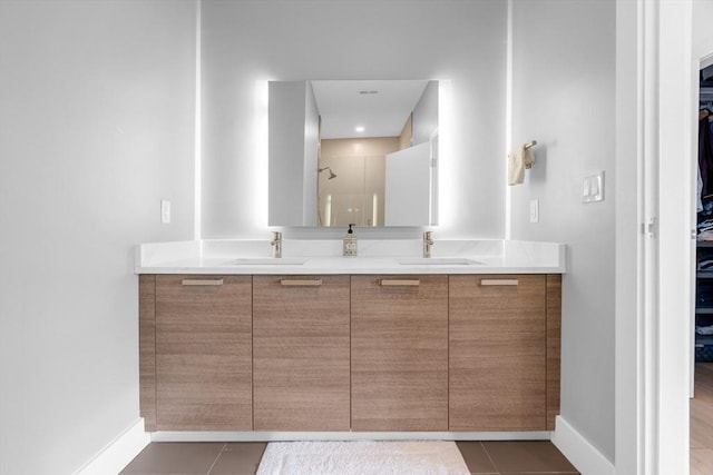 bathroom featuring tile patterned flooring and vanity