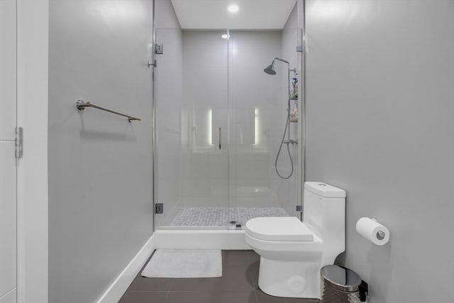 bathroom with toilet, a shower with door, and tile patterned flooring