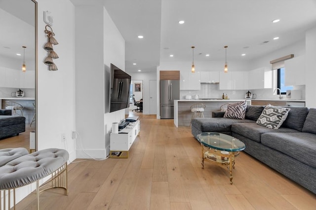 living room featuring sink and light wood-type flooring