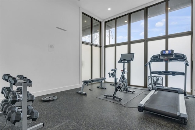 gym featuring expansive windows and a healthy amount of sunlight