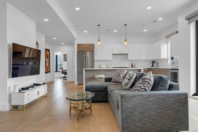 living room featuring light hardwood / wood-style floors and beverage cooler