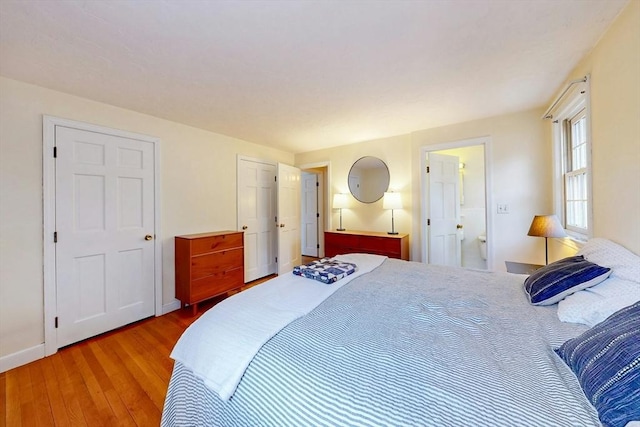 bedroom featuring baseboards and wood finished floors