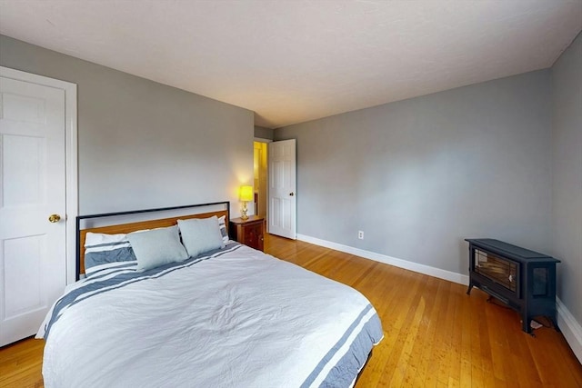 bedroom featuring baseboards and wood finished floors