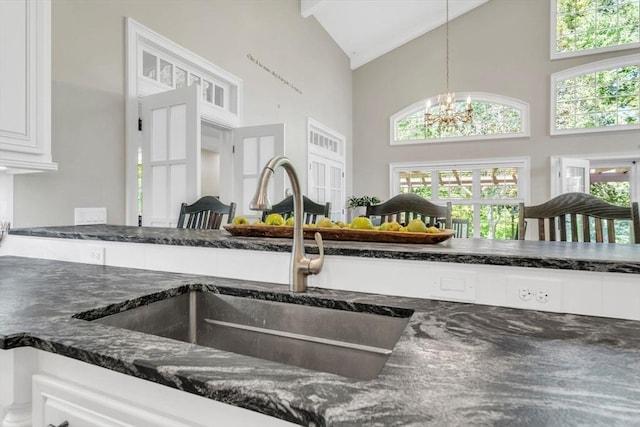 8 Fitch Farm Way, Southampton, MA 01073 - kitchen view of a sink, dark stone countertops, a chandelier, hanging light fixtures, and white cabinetry