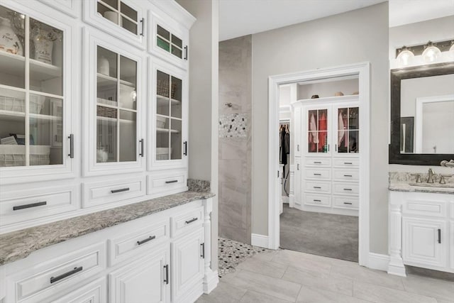 8 Fitch Farm Way, Southampton, MA 01073 - bathroom with vanity, tiled shower, baseboards, and a closet