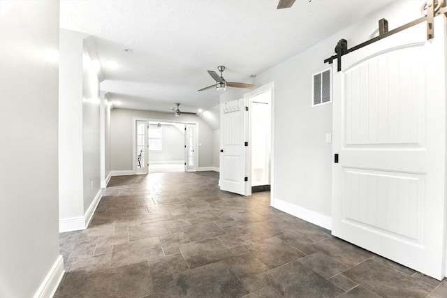 8 Fitch Farm Way, Southampton, MA 01073 - unfurnished living room with a barn door, ceiling fan, baseboards, and stone finish floors