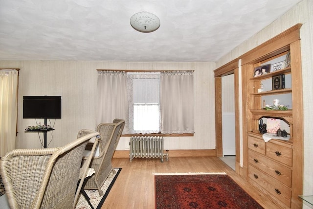 office with radiator heating unit, wood finished floors, and baseboards