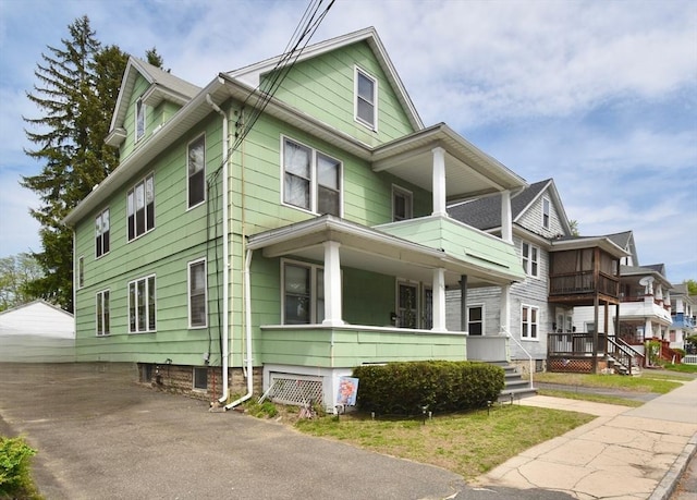 view of front facade with covered porch and a balcony