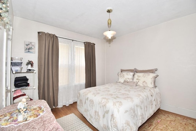 bedroom with light wood-style flooring and baseboards