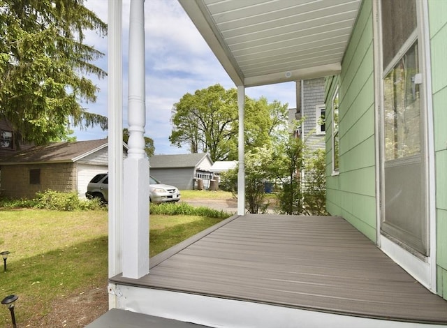 wooden terrace with a lawn
