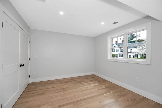 unfurnished bedroom with baseboards, recessed lighting, and light wood-style floors