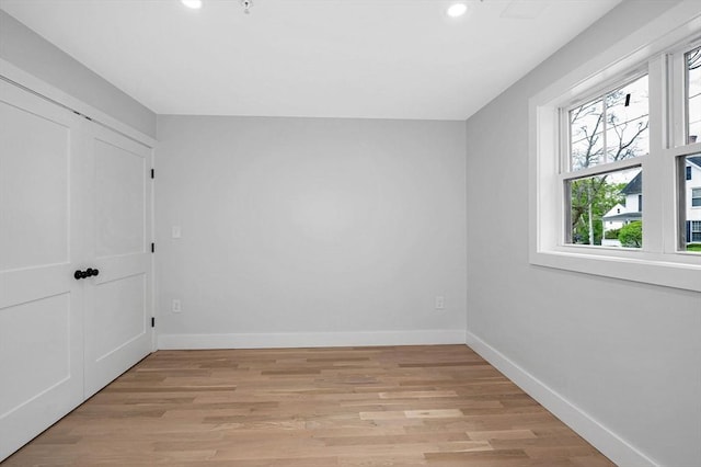 unfurnished bedroom with recessed lighting, baseboards, and light wood finished floors