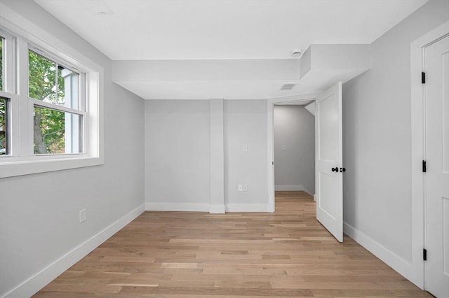below grade area with baseboards and light wood-style flooring