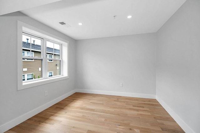 spare room featuring baseboards, light wood finished floors, recessed lighting, and fire sprinkler in ceiling