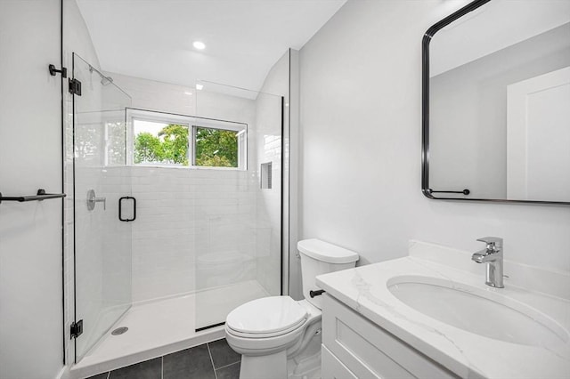 full bathroom featuring toilet, a stall shower, vanity, and tile patterned floors