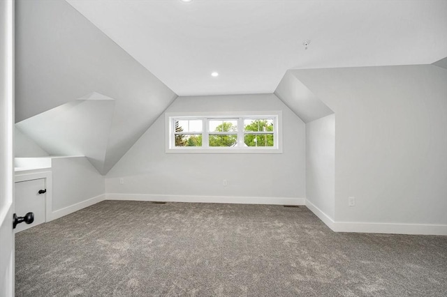 additional living space with carpet flooring, vaulted ceiling, baseboards, and recessed lighting